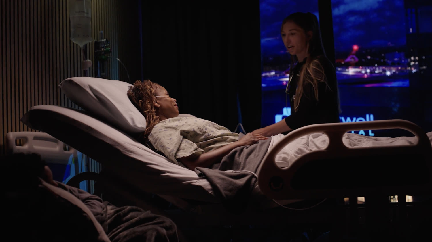 The final graded hospital scene at Studio C with a hospital bed and large window overlooking the hospital and helipad.