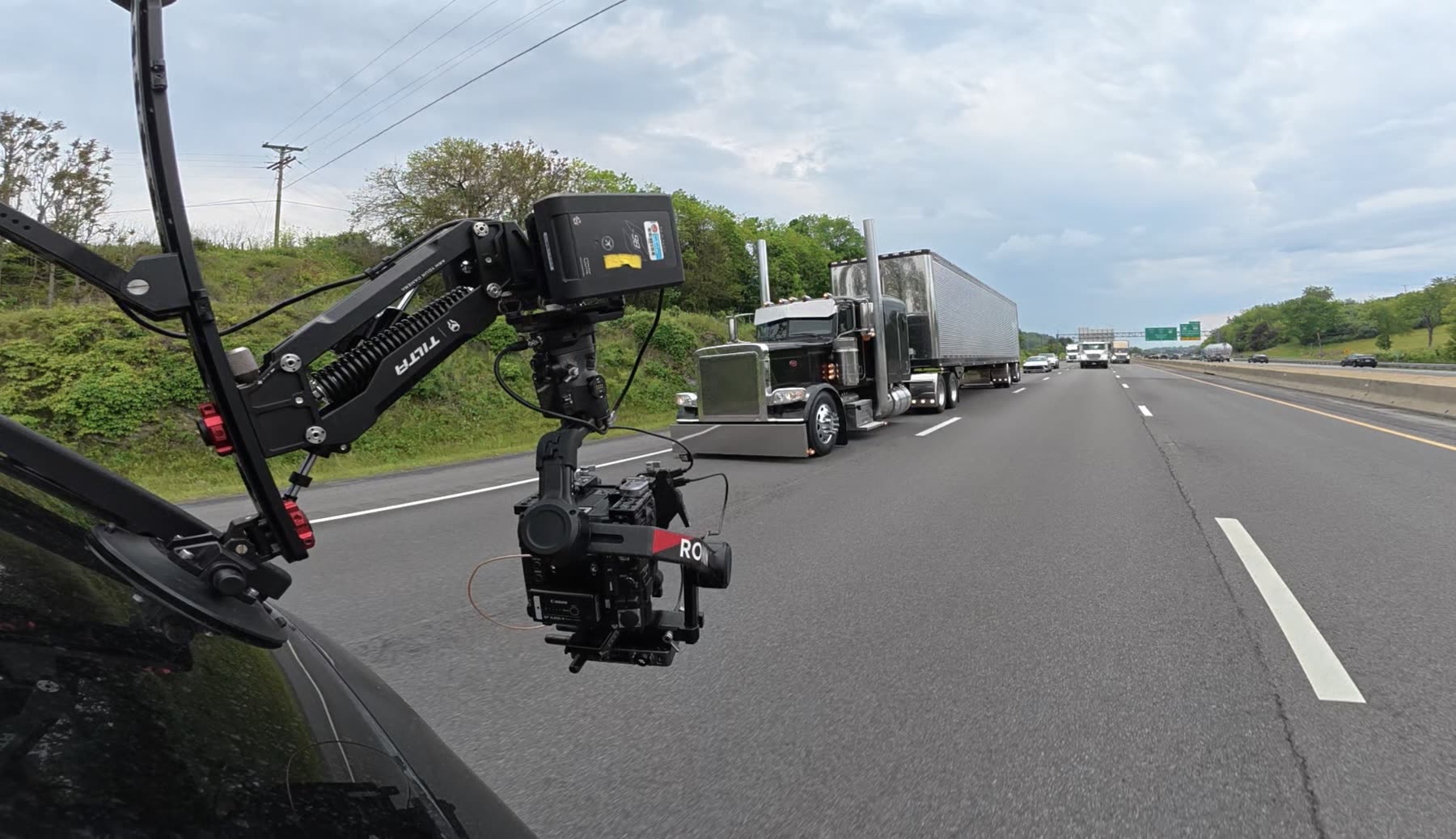 A camera-car rig films the Mercer Transportation Peterbilt at speed on the highway in North Carolina.