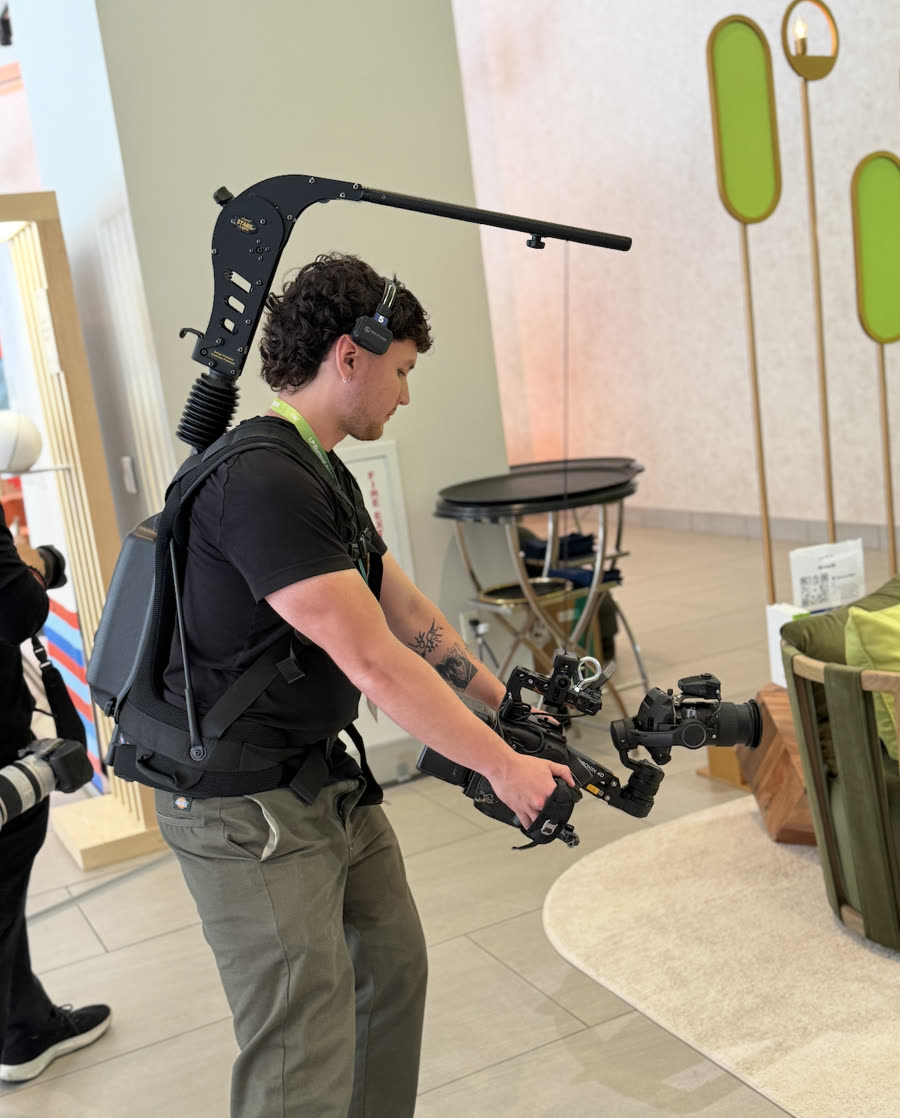 A camera operator filming with an Easyrig at the  a16z LP Summit in Las Vegas.