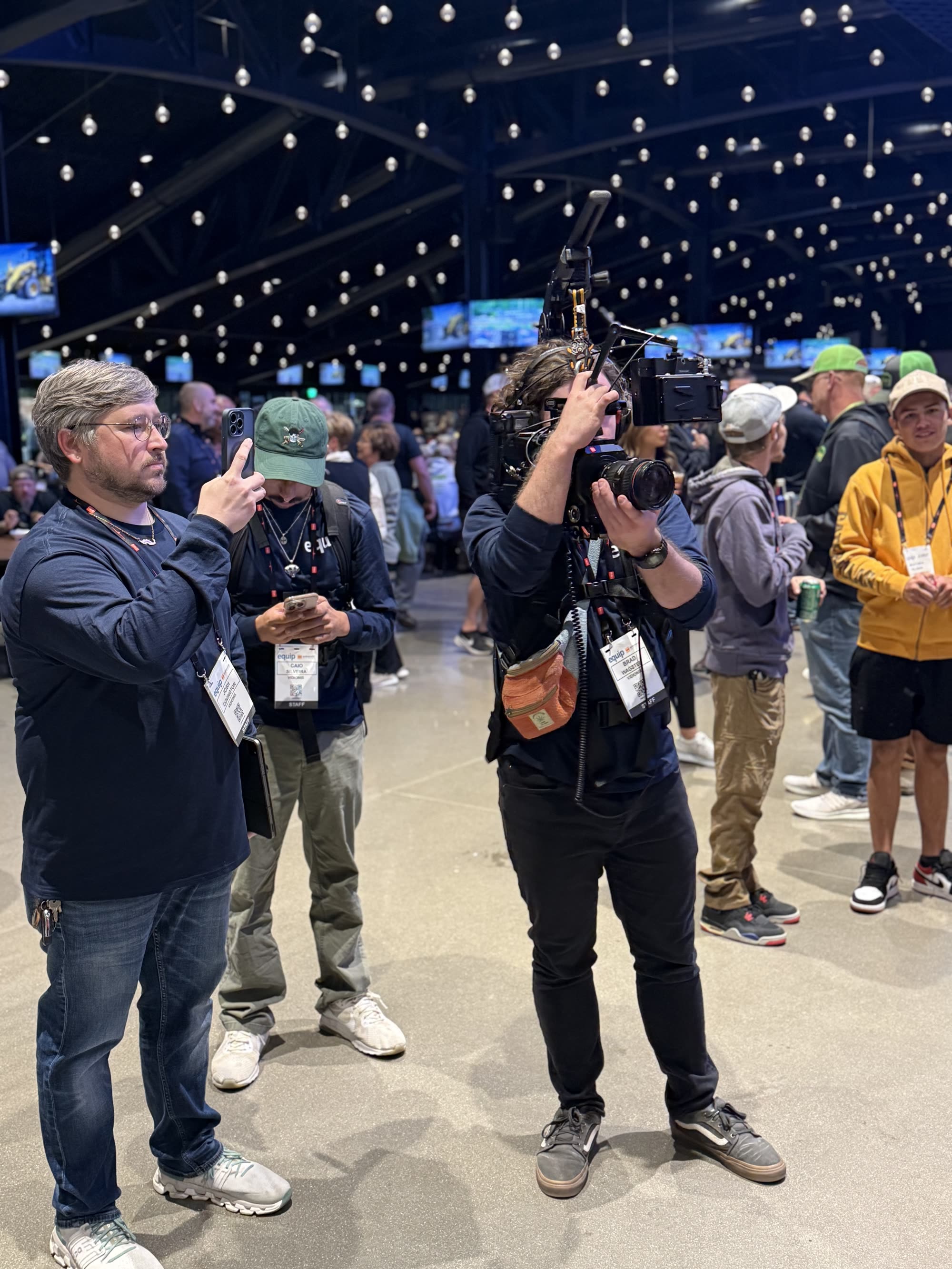Behind the scenes at Equip Exposition as a camera team films an interview.