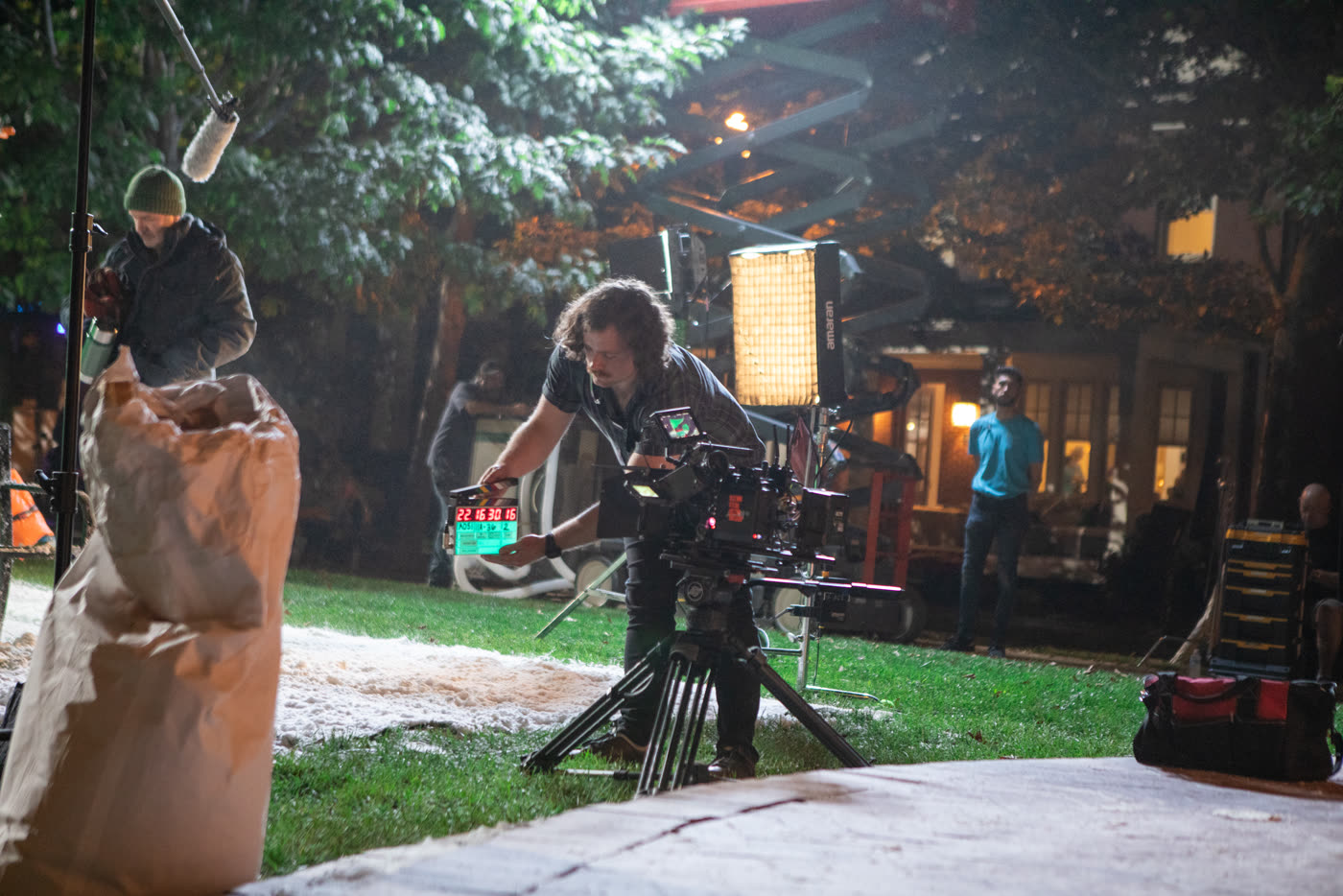 A camera technician holds a digital slate in front of the Arri Alexa camera, behind the scenes of a Hallmark commercial.
