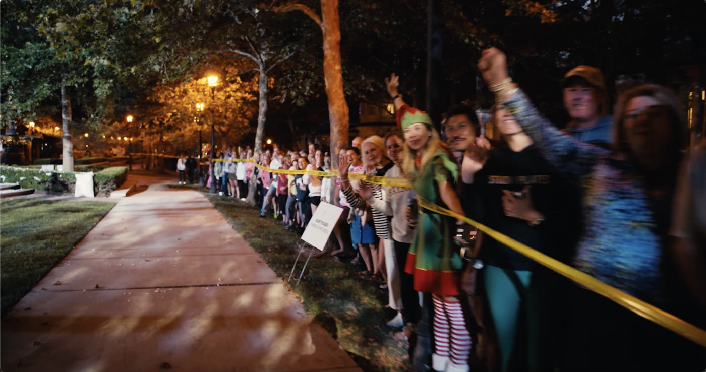 A large crowd gathers watching filming on the set of the Hallmark Winter Walk shoot