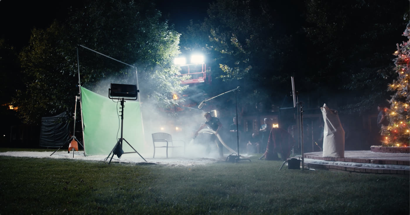A technician lays down fake snow on the set of the Hallmark Winter Walk shoot