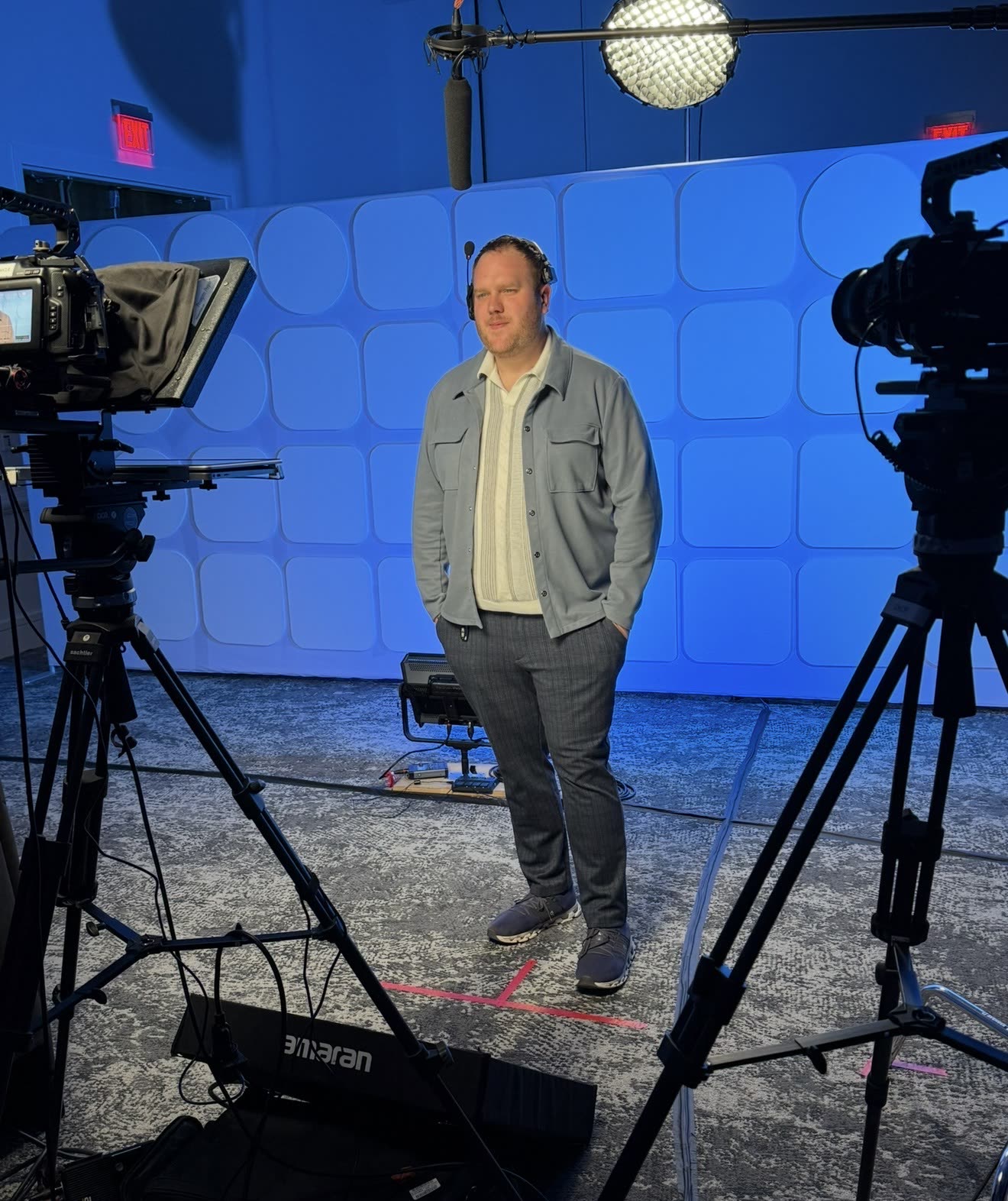 Producer Zach Meiners standing in front of cameras at the HP roadshow pop-up studio