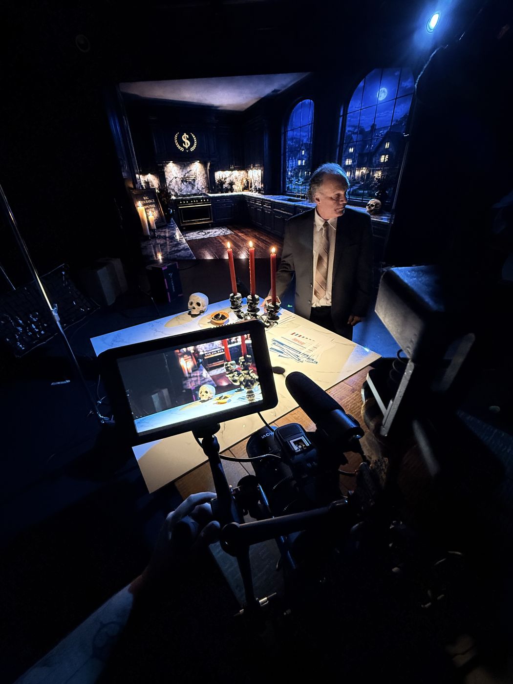 The Insurance Man at his candlelit desk, stamping claims on the Studio C set.