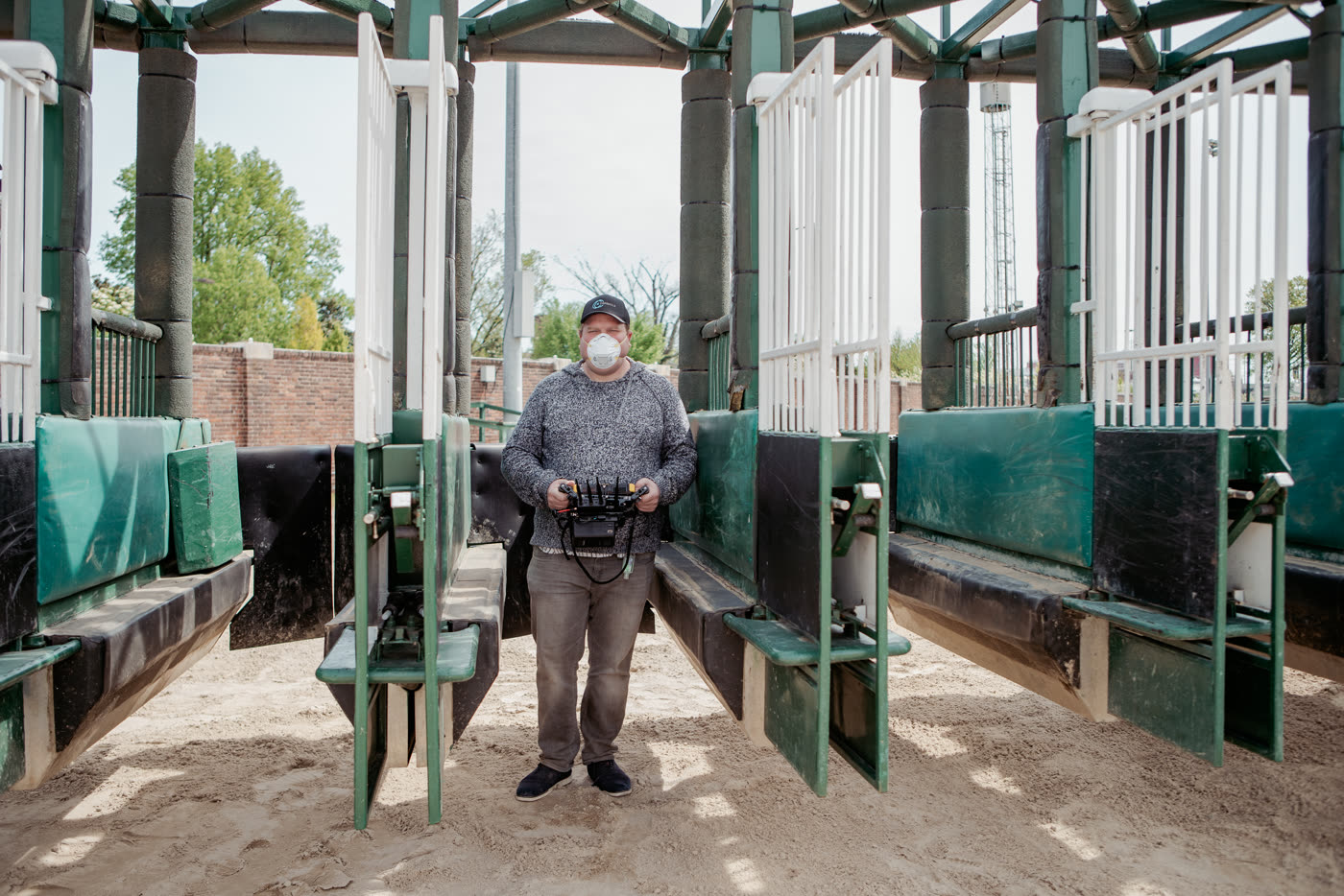 Director Zach Meiners films in the starting gates at Churchill Downs on the set of the Woodford Reserve shoot with Ben Sollee
